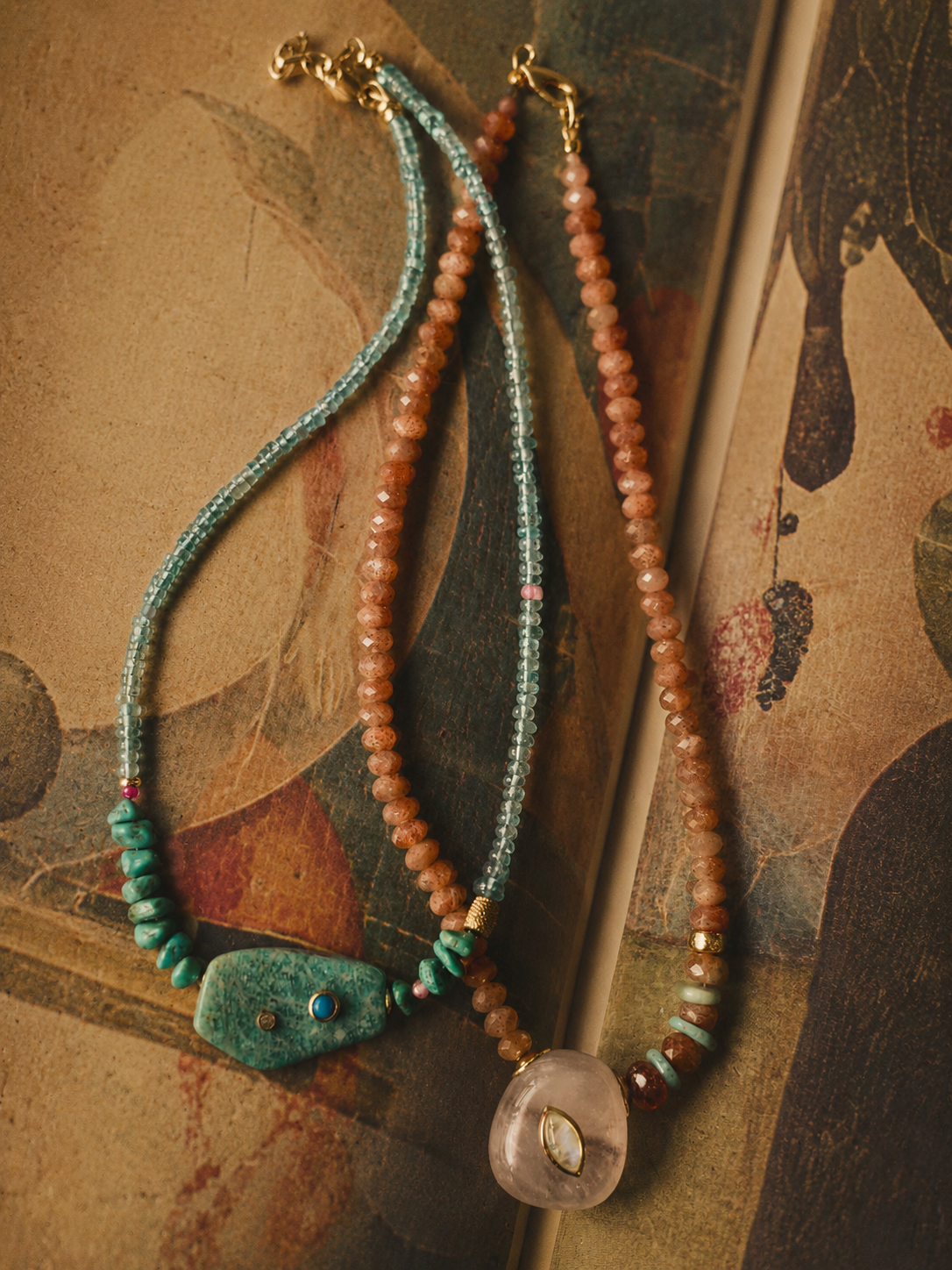 Handcrafted focal pieces featuring natural stones, shells, and symbolic treasures, designed to anchor your adornments with beauty and meaning.