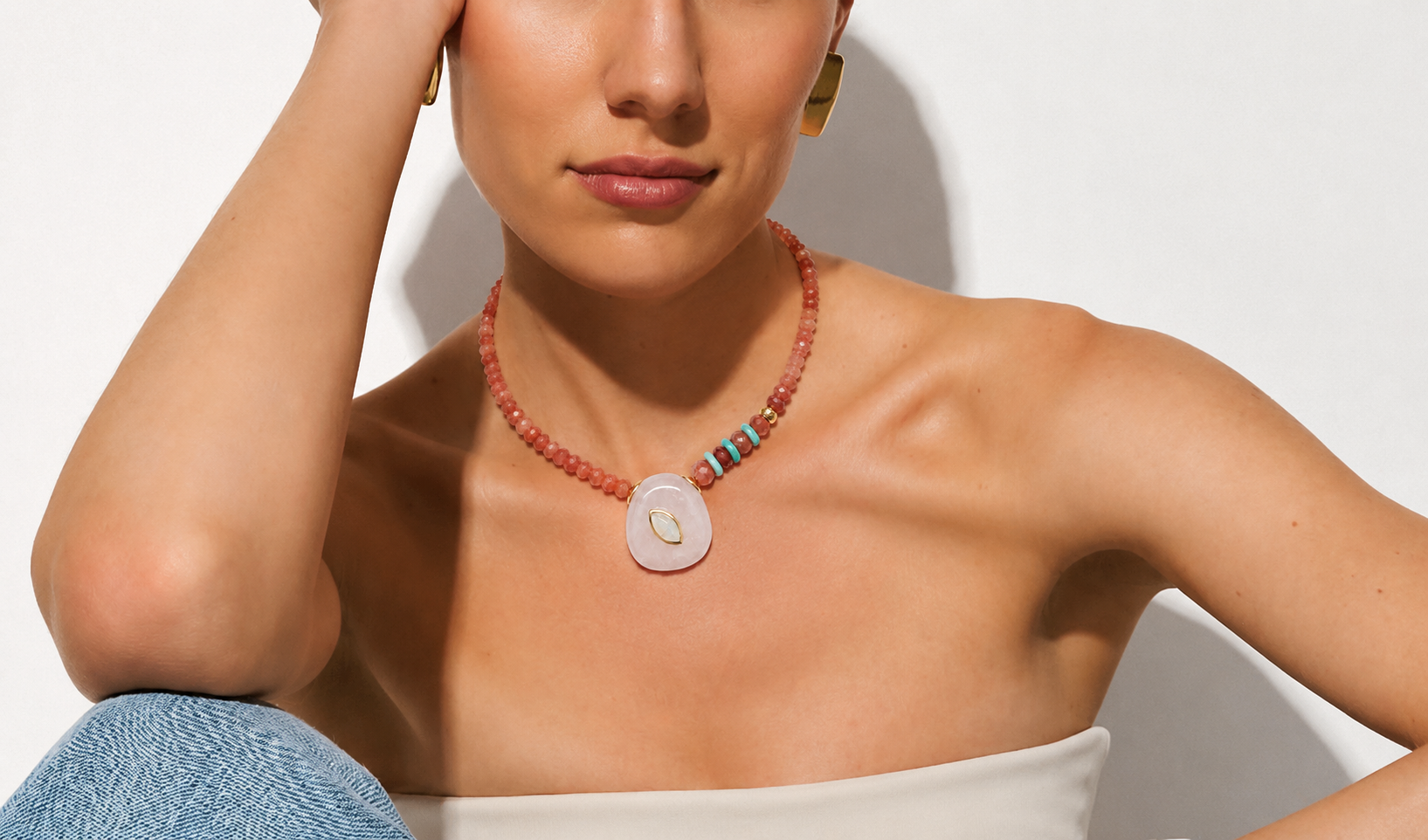 Model wearing the Seraphine focal necklace featuring a lavender amethyst pendant with rainbow moonstone detail, sunstone gemstone strand, amazonite accents, and gold-plated findings.